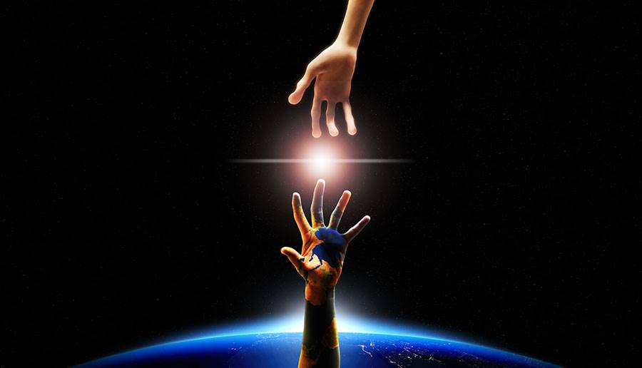 alien and human hand connecting