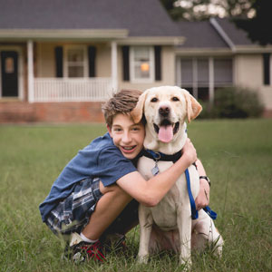 Samuel and his amazing assistance dog FLASH. Photograph Credit: Urso Photography.
