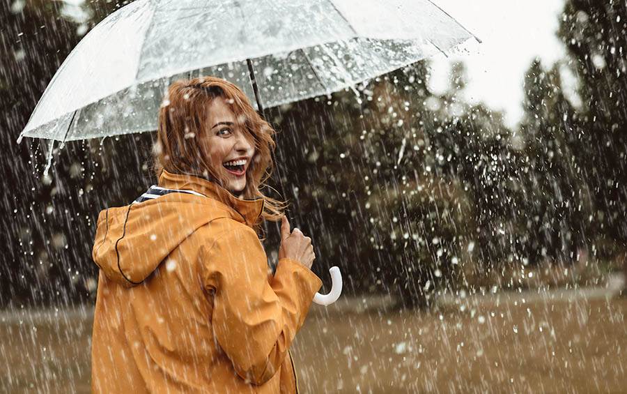 Happy woman in the rain